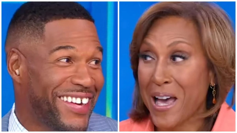 Michael Strahan prende in giro Robin Roberts dicendole di essere in una posizione scottante mentre torna al GMA